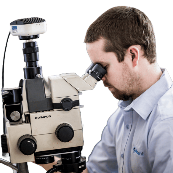 Materials testing scientist using microscope for quality analysis at Element laboratory