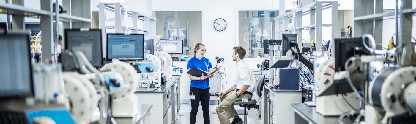 Element medical device testing engineers in lab with stent graft testing equipment