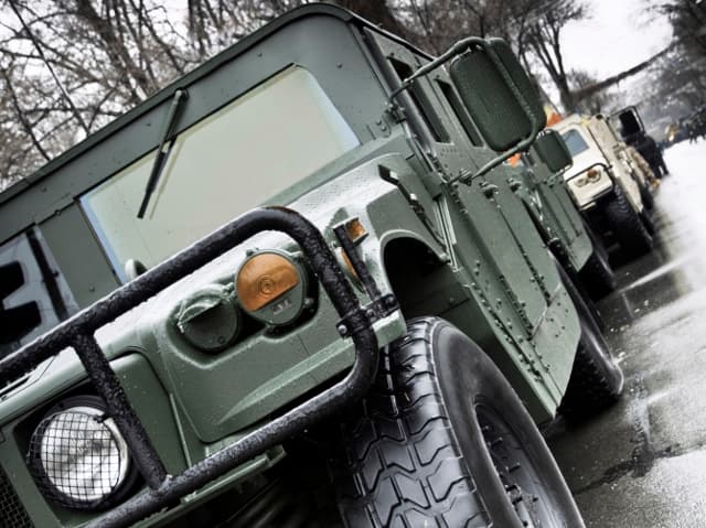 Service member in front of a sunset background operating drone that has undergone military and aerospace component certification