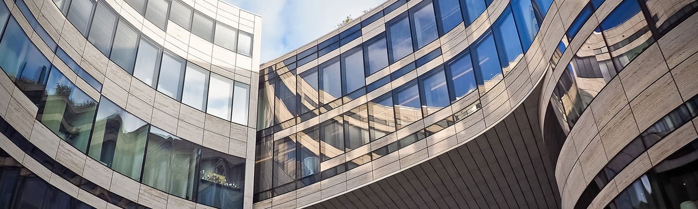 Curved buildings featuring large glass windows