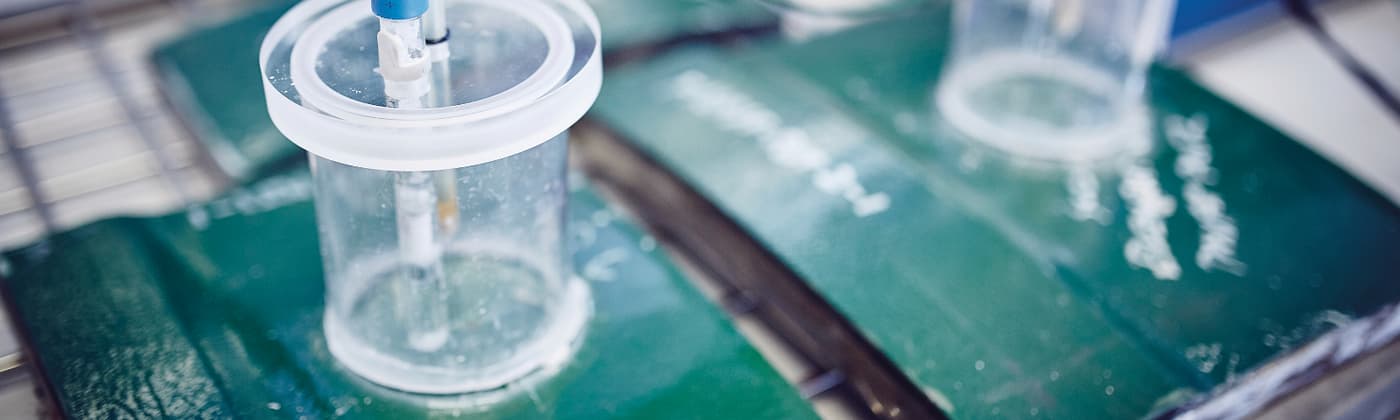 Testing equipment for coatings sitting on a green coating sample surface taking measurements