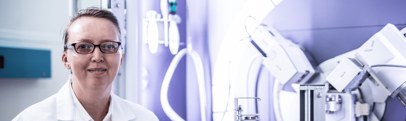 Element pharmaceutical testing scientist with laboratory equipment for drug development and compliance