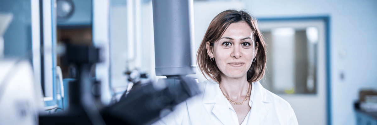 Element scientist in white lab coat working in life sciences testing laboratory